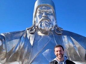 Steve Sir poses in front of a statue of Genghis Khan, located outside the Mongolian capital city of Ulaanbaatar.
