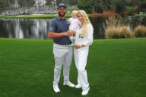 Jon Rahm with wife Kelley Cahill and son Kepa during Wednesday’s Par 3 contest at Augusta National. GETTY IMAGES