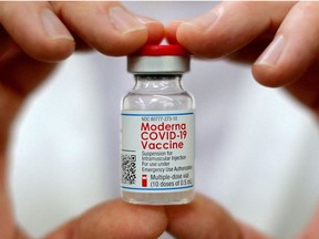 A pharmacist holds a vial of the Moderna coronavirus disease (COVID-19) vaccine in West Haven, Connecticut, U.S., February 17, 2021.