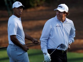 U.S. golfers Tiger Woods and Phil Mickelson walk to the 11th tee during the second day of practice for the 2018 Masters golf tournament at Augusta National Golf Club in Augusta, Georgia, U.S. April 3, 2018.