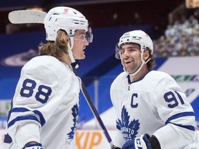 Toronto Maple Leafs' John Tavares, right, and William Nylander celebrate Tavares' goal against the Vancouver Canucks during the first period of an NHL hockey game in Vancouver, on Tuesday, April 20, 2021.