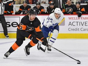 Philadelphia Flyers defenseman Cam York controls the puck against Toronto Maple Leafs center David Kampf during the first period at Wells Fargo Center.