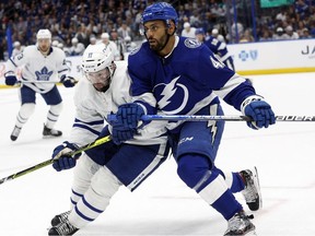 Apr 4, 2022; Tampa, Florida, USA; Toronto Maple Leafs center Colin Blackwell (11) and left wing Pierre-Edouard Bellemare (41) skate after the puck during the second period at Amalie Arena.