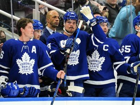 Apr 9, 2022; Toronto, Ontario, CAN; Toronto Maple Leafs forward Auston Matthews (middle) acknowledges a tribute by fans after setting a new Maple Leafs single season record for goals during a break in the action against the Montreal Canadiens at Scotiabank Arena.