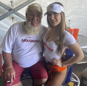 Legendary Hooters fan and golfer John Daly with a server. HANDOUT/HOOTERS