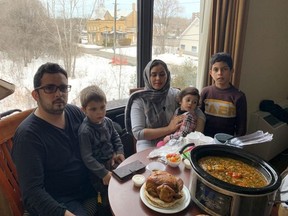 Former NATO interpreter Ahmad “Radar” Sidiqi is pictured with his family in an Ottawa hotel room.