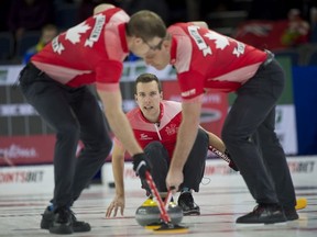 Lethbridge Ab,March 9, 2022,Tim Hortons Brier.Team Canada skip Brendan Bottcher of Edmonton Ab delivers his stone to his front end (L-R) 2nd.Brad Thiessen and lead Karrick Martin (R) during draw 15 against team Alberta.