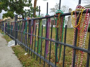 Beads hang on a fence in Bay St. Louis, Miss., a reminder of the area’s annual Mardi Gras celebrations.