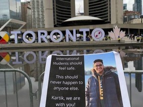 Family and friends held a vigil for slain foreign student Kartik Vasudev at Nathan Phillips Square on Sunday.