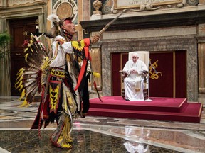 A member of Canada's Indigenous delegation chants and dances before Pope Francis during an audience at the Vatican on Friday, April 1, 2022