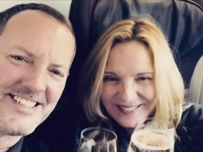 Russell Thomas and Kim Cattrall share a toast in a short video on Instagram, Friday, April 22, 2022.