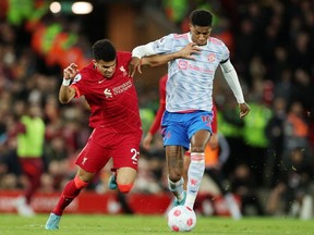 Soccer Football - Premier League - Liverpool v Manchester United - Anfield, Liverpool, Britain - April 19, 2022. Manchester United's Marcus Rashford in action with Liverpool's Luis Diaz.