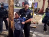 Syracuse Police officer forcing eight-year-old boy into police cruiser after the child allegedly stole a bag of chips.