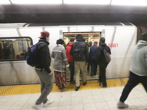 Commuters board a southbound train at Yonge-Blood station on Friday, April 22, 2022.