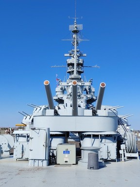 The big guns of the USS Alabama stand silent at its mooring in Mobile, Ala.