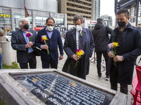 On the fourth anniversary of the deadly Yonge St. van attack Willowdale MPP Stan Cho (from right), Toronto Mayor John Tory, Willowdale MP Ali Ehsassi and Willowdale Coun.John Filion prepare to place flowers during a memorial at North York’s Mel Lastman Square on Saturday, April 23, 2022.