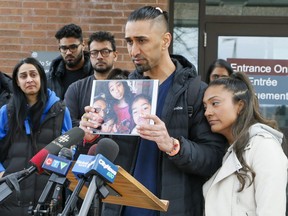 Ketan Chaudhari, centre, and Binta Patel, right, speak to the media after the sentencing in Newmarket court on Monday, April 4, 2022 for the 16-year-old boy who fatally hit Anaya Chaudhari, 10, and Jax Chaudhari, 4, in the family's Vaughan driveway in May 2021.