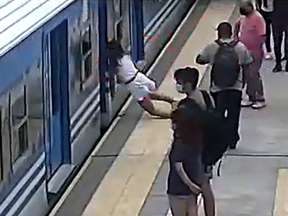Screen shot of woman who fainted and fell under moving train in Argentina.