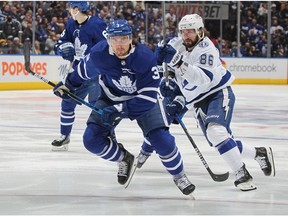 Nikita Kucherov of the Tampa Bay Lightning skates against Justin Holl of the Toronto Maple Leafs during Game Five of the First Round of the 2022 Stanley Cup Playoffs at Scotiabank Arena on May 10, 2022 in Toronto, Ontario, Canada.