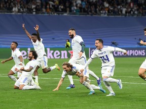 Players of Real Madrid celebrate their side's victory and progression to the UEFA Champions League Final after the UEFA Champions League Semi Final Leg Two match between Real Madrid and Manchester City at Estadio Santiago Bernabeu on May 4, 2022 in Madrid, Spain.