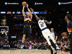 Devin Booker #1 of the Phoenix Suns puts up a shot over Dorian Finney-Smith #10 of the Dallas Mavericks during the second half of Game Two of the Western Conference Second Round NBA Playoffs at Footprint Center on May 4, 2022 in Phoenix, Arizona.