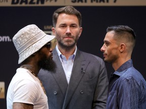 Boxers Montana Love (L) and Gabriel Gollaz Valenzuela (R) face off as Matchroom Sport Chairman Eddie Hearn (C) looks on during a news conference at the KA Theatre at MGM Grand Hotel & Casino on May 5, 2022 in Las Vegas.