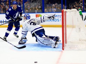 Maple Leafs goaie Jack Campbell stops a shot from Lightning’s Corey Perry in Tampa on Sunday night.