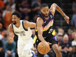 Mikal Bridges of the Phoenix Suns steals the ball from Spencer Dinwiddie of the Dallas Mavericks during the second half of Game Five of the Western Conference Second Round NBA Playoffs at Footprint Center on May 10, 2022 in Phoenix, Arizona.