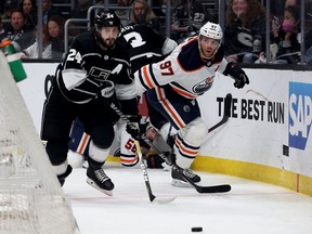 Phillip Danault of the Los Angeles Kings skates to the puck away from Connor McDavid of the Edmonton Oilers during the third period in a 4-2 Oilers win in Game Six of the First Round of the 2022 Stanley Cup Playoffs at Crypto.com Arena on May 12, 2022 in Los Angeles, California.