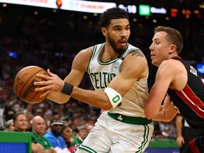Jayson Tatum of the Boston Celtics looks to pass against Duncan Robinson of the Miami Heat during the second quarter in Game 4 of the 2022 NBA Playoffs Eastern Conference Finals at TD Garden on May 23, 2022 in Boston.