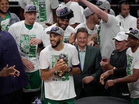 Jayson Tatum #0 of the Boston Celtics celebrates with his teammates after being awarded the Eastern Conference Larry Bird MVP trophy after defeating the Miami Heat with a score of 100 to 96 in Game Seven to win the 2022 NBA Playoffs Eastern Conference Finals at FTX Arena on May 29, 2022 in Miami.