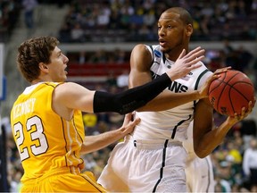 Adreian Payne of the Michigan State Spartans looks to pass in the first half against Matt Kenney of the Valparaiso Crusaders during the second round of the 2013 NCAA Men's Basketball Tournament at at The Palace of Auburn Hills on March 21, 2013 in Auburn Hills, Michigan.