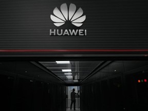 A technician is at the entrance of a Huawei 5G data server center at Guangdong Provincial General Hospital in Guangzhou, Guangdong Province, southern China, on September 26, 2021.