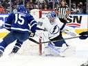 Tampa Bay Lightning goaltender Andrey Vasilevsky (88) saves Toronto Maple Leafs forward Alexander Kerfoot (15) in Game 1 of the 2022 Stanley Cup playoffs at Scotiabank Arena. 