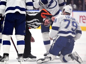 Tampa Bay Lightning forward Ross Colton (79) is examined by referee Dan O'Rourke (9) after being injured from a hit by Toronto Maple Leafs forward Kyle Clifford in Game 1.