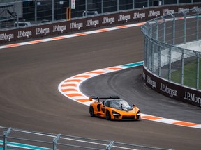 Engineers and officials drive a sport car on the Formula One track ahead of the Miami Grand Prix in Miami Gardens, Florida on May 4, 2022.