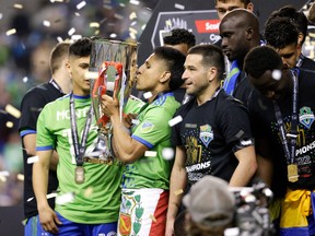 Seattle Sounders forward Raul Ruidiaz kisses the trophy as the team celebrates their victory in the CONCACAF Champions League final match between Seattle Sounders and Pumas UNAM at Lumen Field in Seattle, Washington on May 4, 2022.