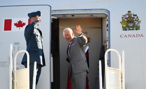 Prince Charles waves as he and Camilla, Duchess of Cornwall (behind), board their plane as they depart Yellowknife, Northwest Territory, at the end of the Royal Tour of Canada, May 19, 2022. PATRICK T. FALLON/AFP via Getty Images