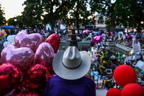 A man visits a makeshift memorial for the shooting victims outside the Uvalde County Courthouse in Uvalde, Texas on May 29, 2022.