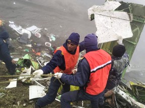 This handout photograph taken on May 30, 2022 and released by the Nepal Police shows members of a rescue team carrying out a operation at the crash site of a Twin Otter aircraft, operated by Nepali carrier Tara Air, on a mountainside in Mustang, a day after it crashed. 
(Photo by MAN BAHADUR BASYAL/Nepal Police/AFP via Getty Images)