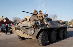Members of the pro-Russian troop service are seen atop an armored vehicle during the Ukraine-Russia conflict in the village of Bezimenne, in the Donetsk region, Ukraine, on May 7, 2022.