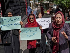 Members of Afghanistan's Powerful Women Movement take part in a protest in Kabul, May 10, 2022.