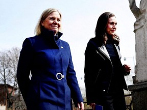 Sweden's Prime Minister Magdalena Andersson, left, walks with Finland's Prime Minister Sanna Marin prior to a meeting, amid Russia's invasion of Ukraine, in Stockholm, April 13, 2022.