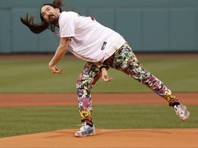 American DJ Steve Aoki delivers the first pitch before the game between the Boston Red Sox and the Houston Astros at Fenway Park on May 16, 2022 in Boston, Massachusetts.