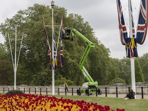 Union flags are hung outside Buckingham Palace in preparation for the Queen's platinum Jubilee, on May 4, 2022 in London.