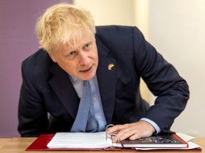 British Prime Minister Boris Johnson takes a seat during a visit to the CityFibre Training Academy in Stockton-on-Tees, Britain May 27, 2022.
