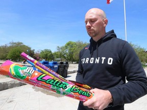 Toronto city councillor Brad Bradford of Ward 19, Beaches-East York holds some of the spent and discarded fireworks he picked up during a short walk near Woodbine Beach, Tuesday May 24, 2022.