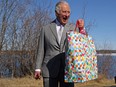 Prince Charles holds a bag as he reacts near the Great Slave Lake on the final day of his Canadian 2022 Royal Tour in Yellowknife, Northwest Territories, May 19, 2022.