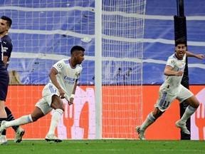 Real Madrid's Brazilian forward Rodrygo ( centre right) celebrates scoring his team's first goal during the UEFA Champions League semi-final second leg between Real Madrid CF and Manchester City at the Santiago Bernabeu stadium on Wednesday. JAVIER SORIANO / AFP (Photo by JAVIER SORIANO/AFP via Getty Images)