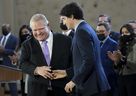Prime Minister Justin Trudeau, right, shakes hands with Ontario Premier Doug Ford after reaching and agreement in $10-a-day child-care program deal in Brampton, Ont., on Monday, March 28, 2022. THE CANADIAN PRESS/Nathan Denette